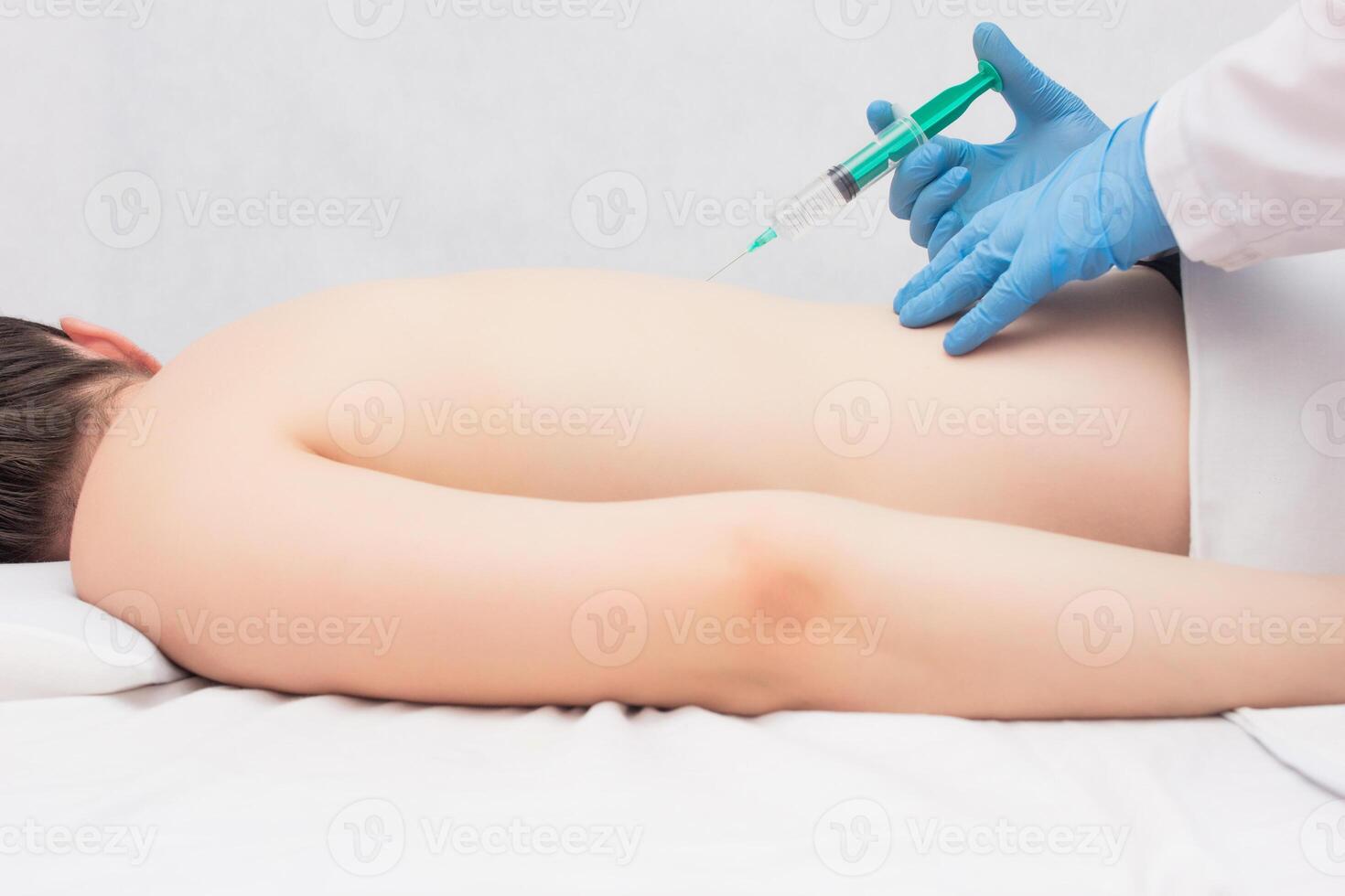 The doctor makes the patient with a painkiller and chondroprotector, problems with inflammation in the back, spinal hernia photo