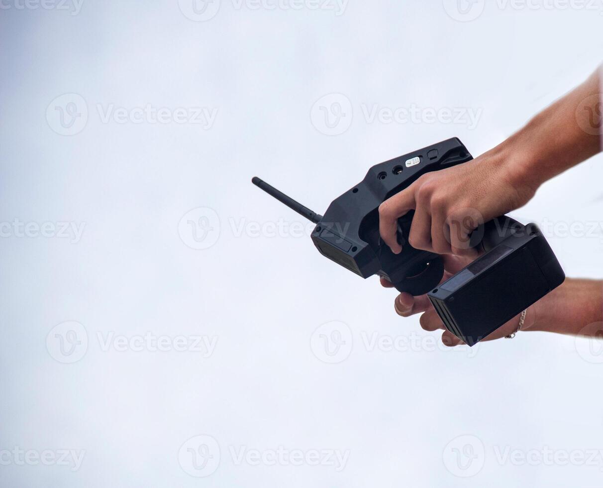 A man holds a radio-controlled remote in the hands of the car, competitions in radio-controlled models, toys, remote control, copy-space, controlled photo