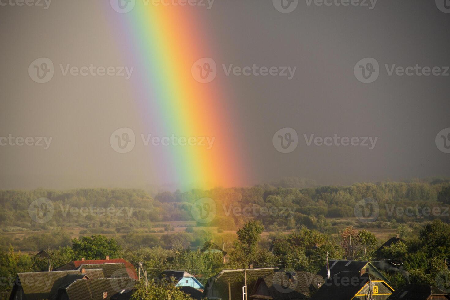Part of a large rainbow over the private sector, close-up, a rainbow over a residential area of the city photo