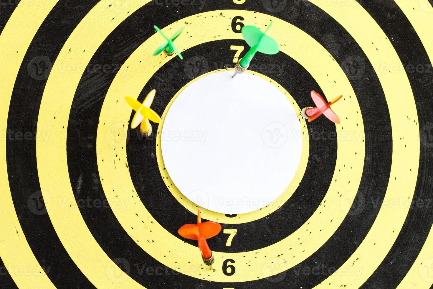 A target with darts in the center of which an empty inscription space photo