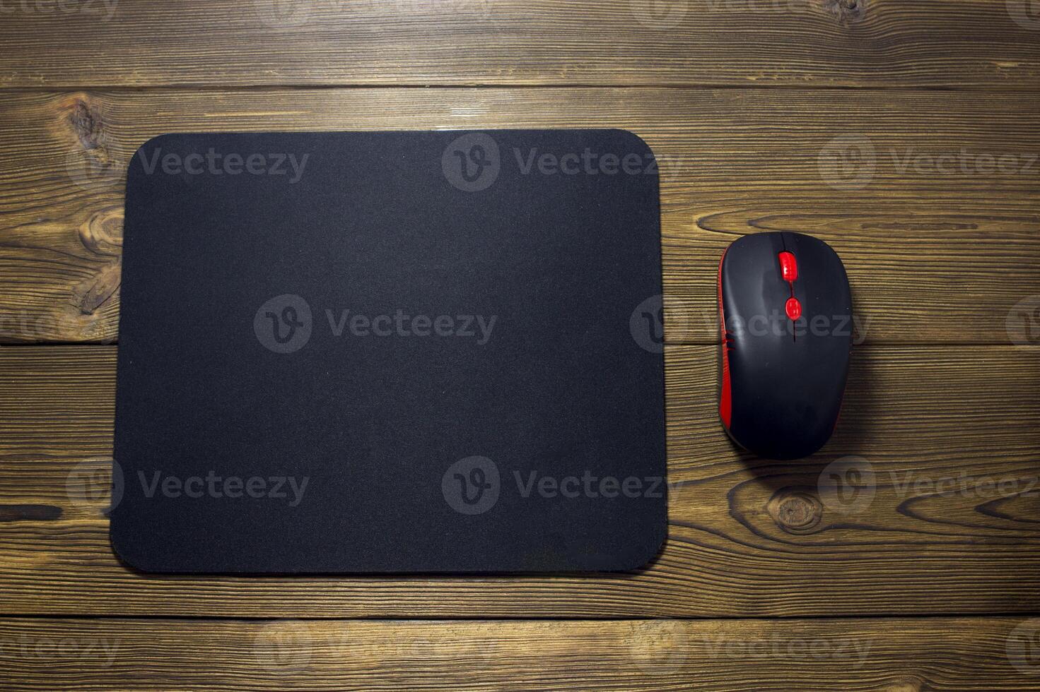 Computer mouse pad and mouse on a wooden background photo