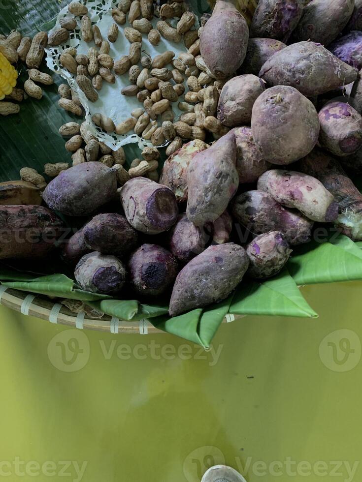 Traditional healthy snacks menu for parties in Indonesia, there are sweet corn, stewed peanuts, potatoes, bananas and breadfruit fresh from steamer. photo