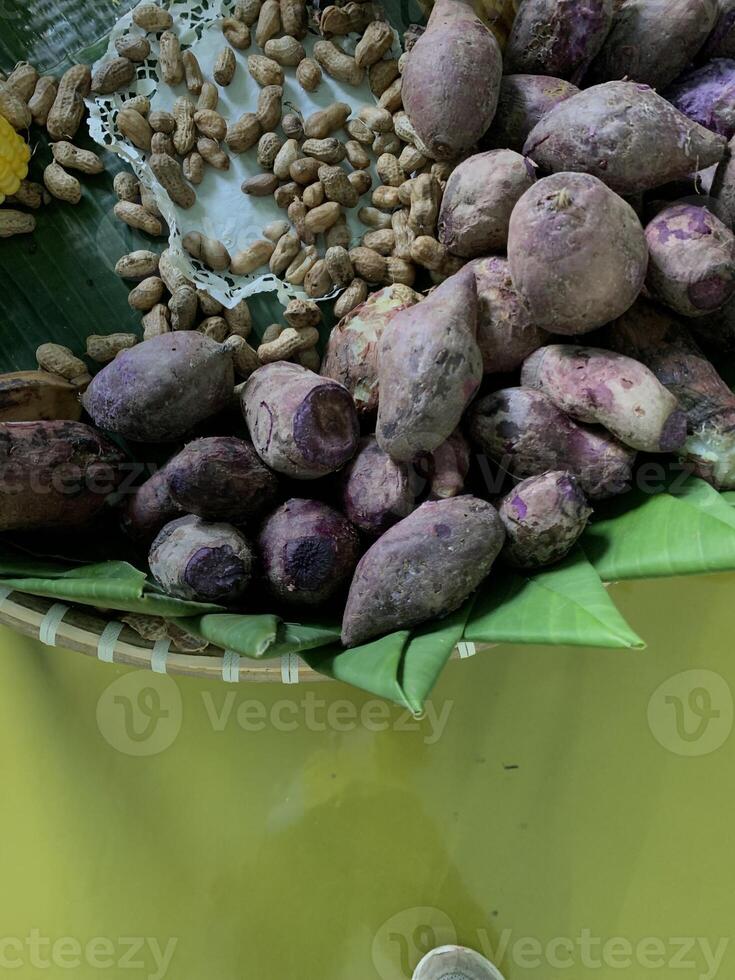 Traditional healthy snacks menu for parties in Indonesia, there are sweet corn, stewed peanuts, potatoes, bananas and breadfruit fresh from steamer. photo