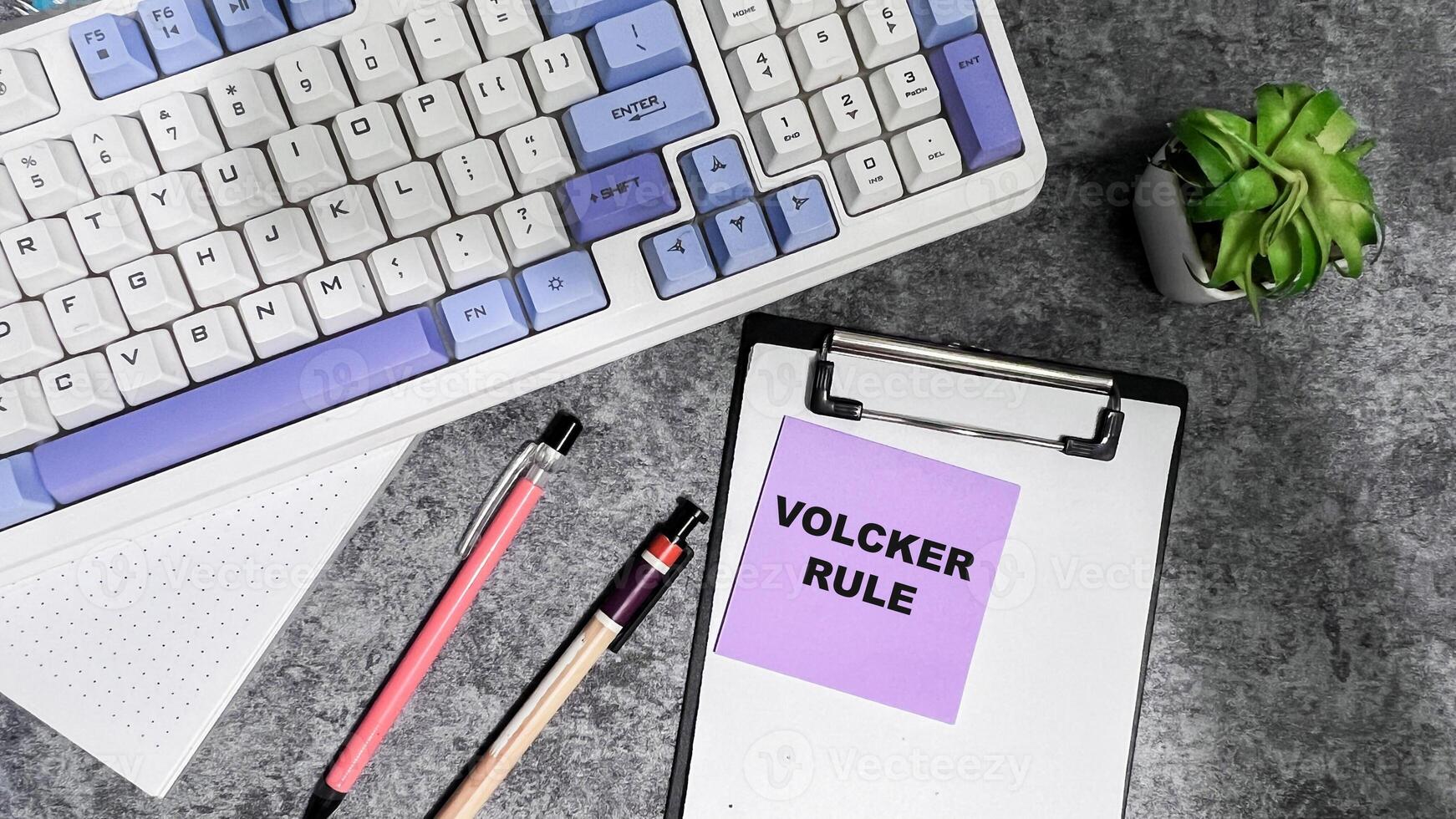 Concept of Volcker Rule write on sticky notes isolated on Wooden Table. photo