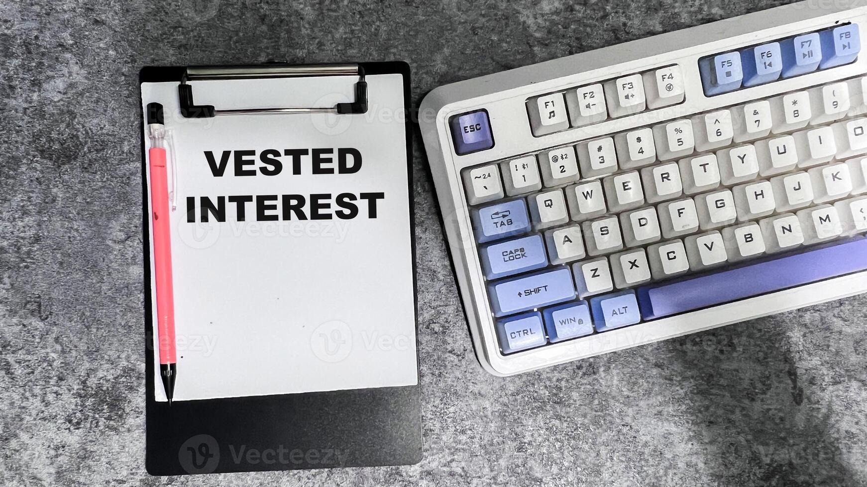 Concept of Vested Interest write on paperwork isolated on Wooden Table. photo