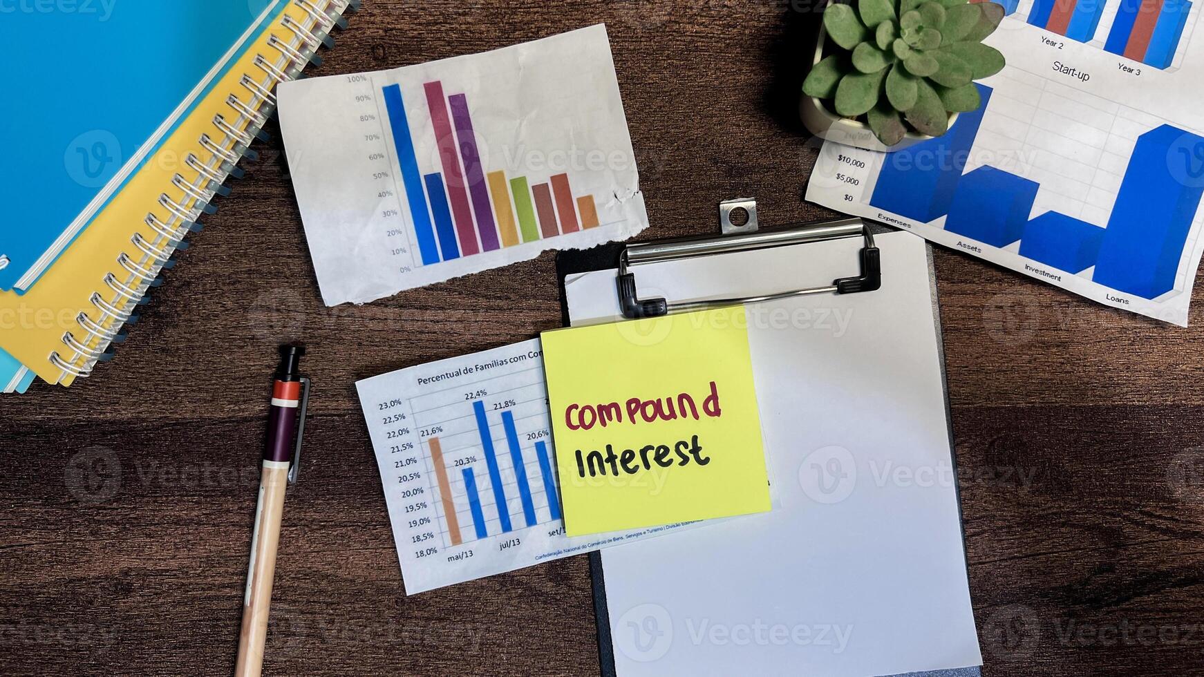 Concept of Compound Interest write on sticky notes isolated on Wooden Table. photo