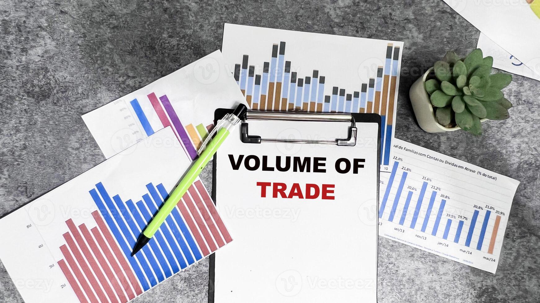 Concept of Volume of Trade write on paperwork isolated on Wooden Table. photo