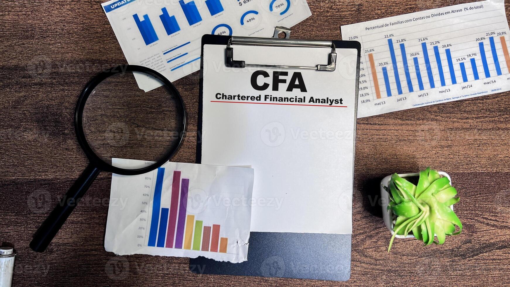 Concept of CFA - Chartered Financial Analyst write on paperwork isolated on Wooden Table. photo