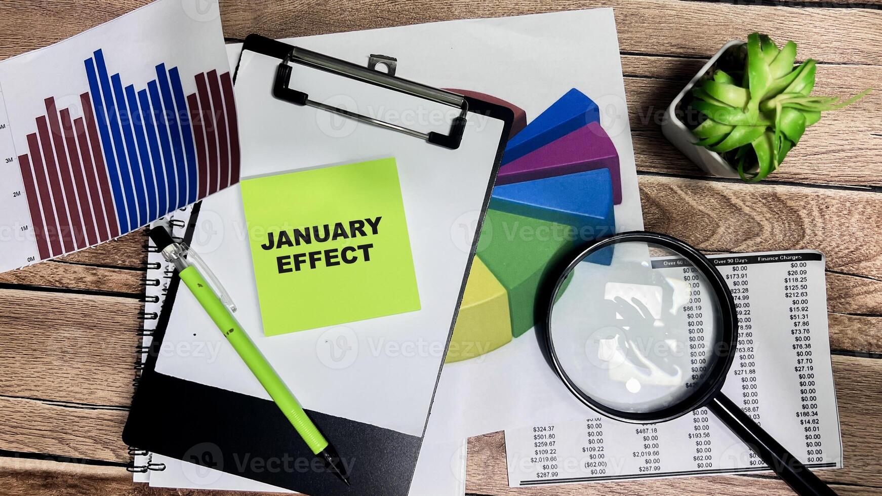 Concept of January Effect write on sticky notes isolated on Wooden Table. photo