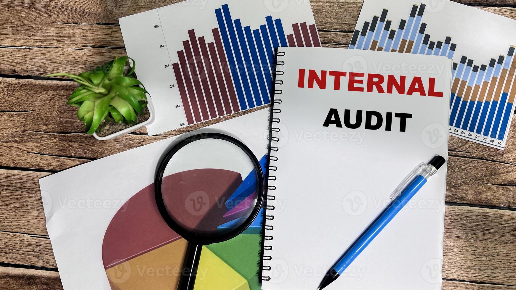 Concept of Internal Audit write on book isolated on Wooden Table. photo