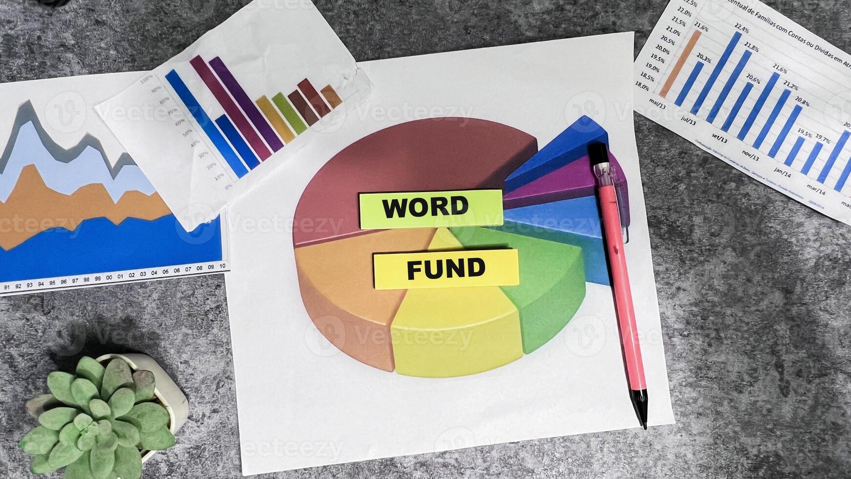 Concept of Word Fund write on sticky notes isolated on Wooden Table. photo