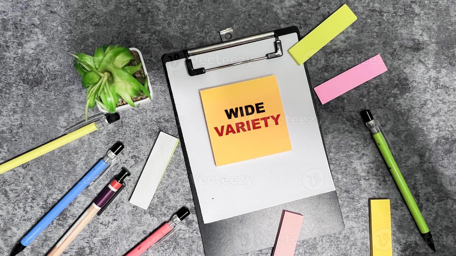 Concept of Wide Variety write on sticky notes isolated on Wooden Table. photo