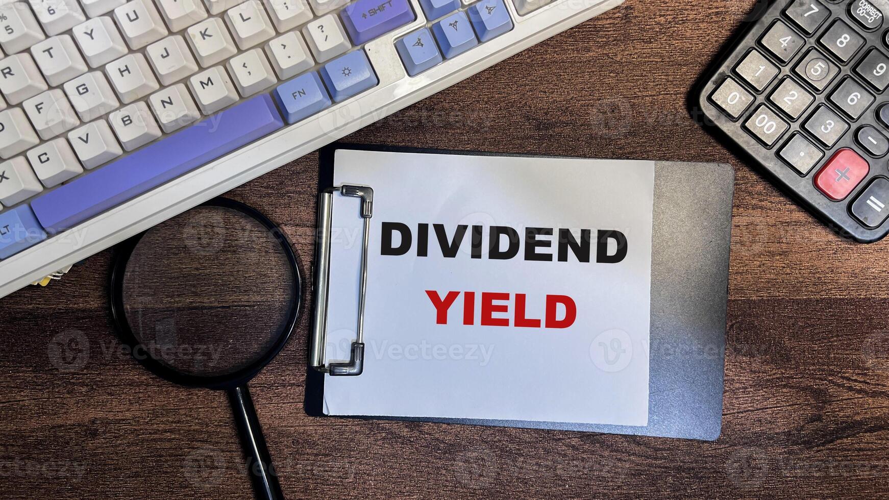 Concept of Dividend Yield write on paperwork isolated on Wooden Table. photo