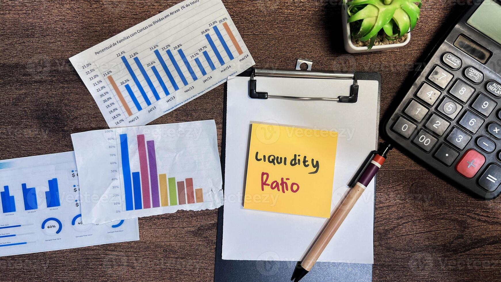 Concept of Liquidity Ratio write on sticky notes isolated on Wooden Table. photo