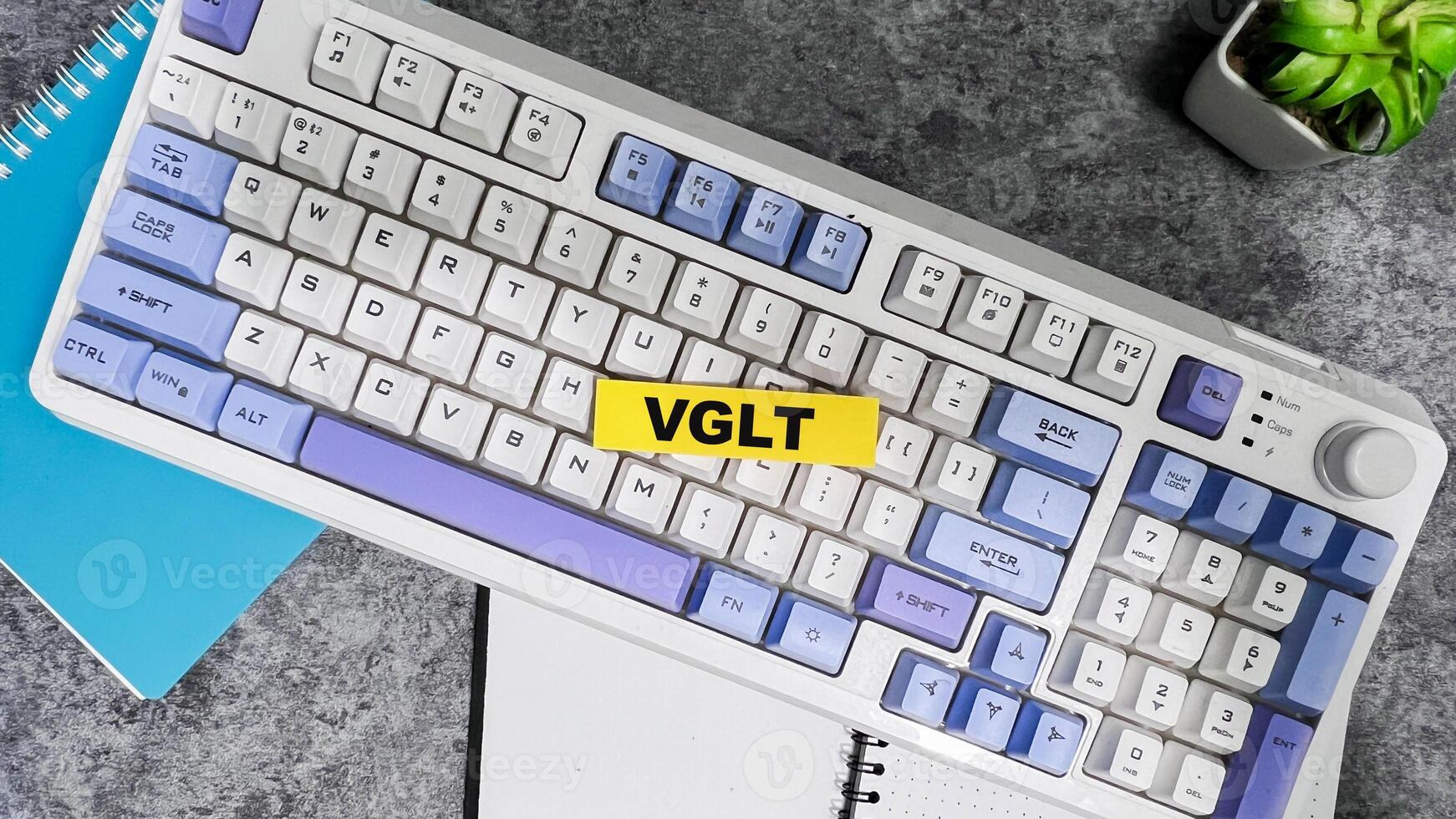 Concept of VGLT write on sticky notes isolated on Wooden Table. photo