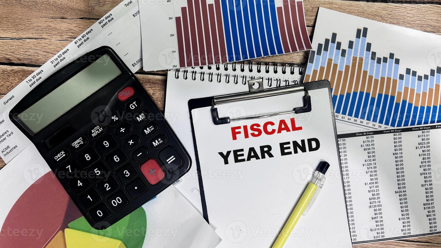 Concept of Fiscal Year End write on paperwork isolated on Wooden Table. photo