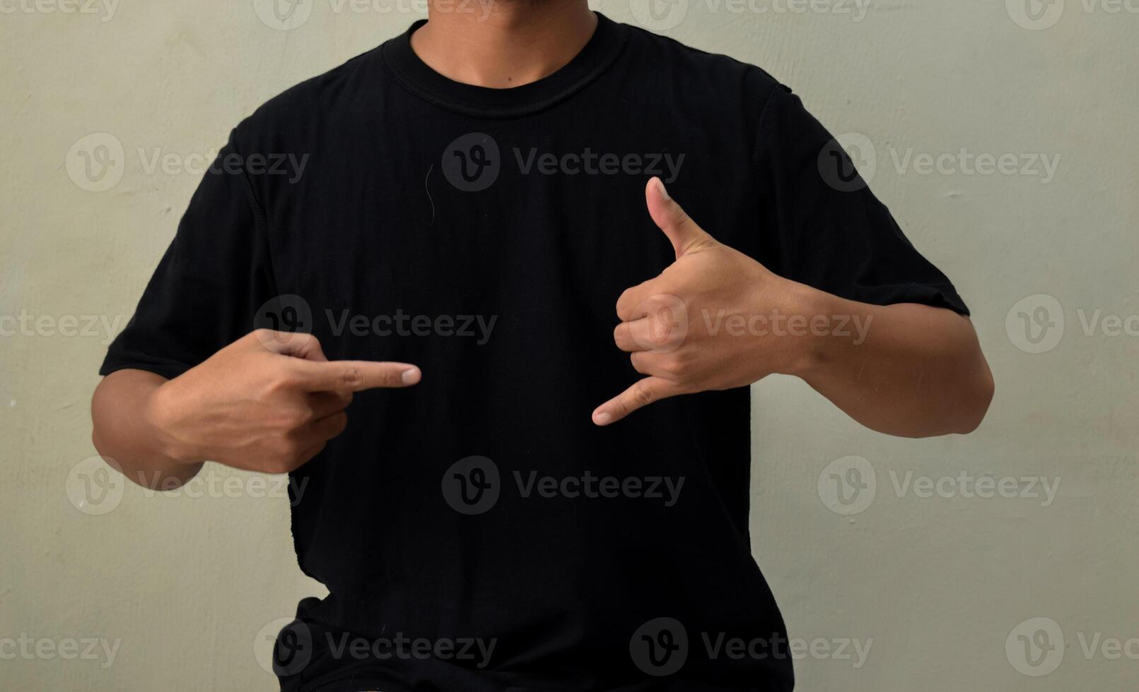 Young man showing CALL ME gesture in sign language photo