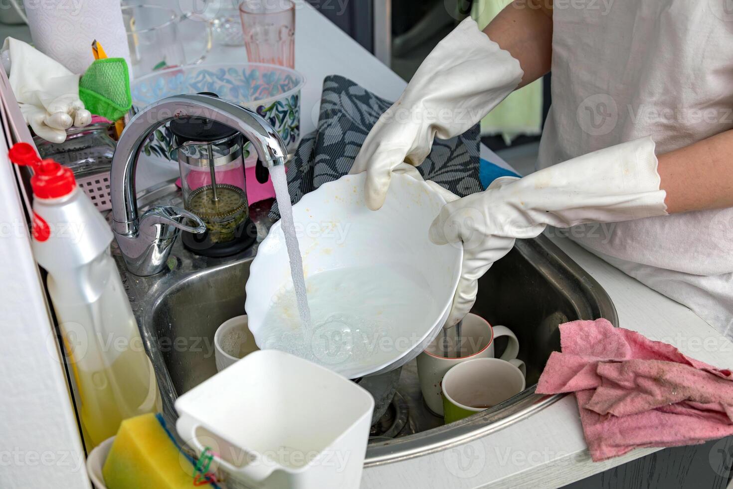 Woman washing dishes in the kitchen photo