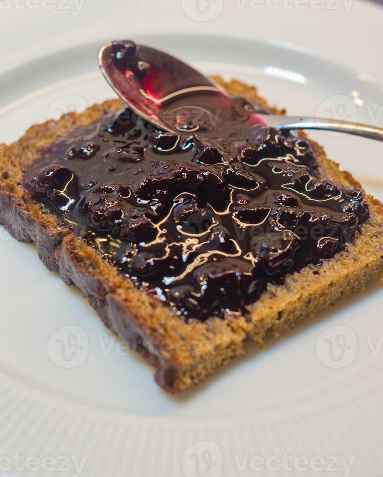 A slice of toast spread with homemade wild berry jam. High quality photo