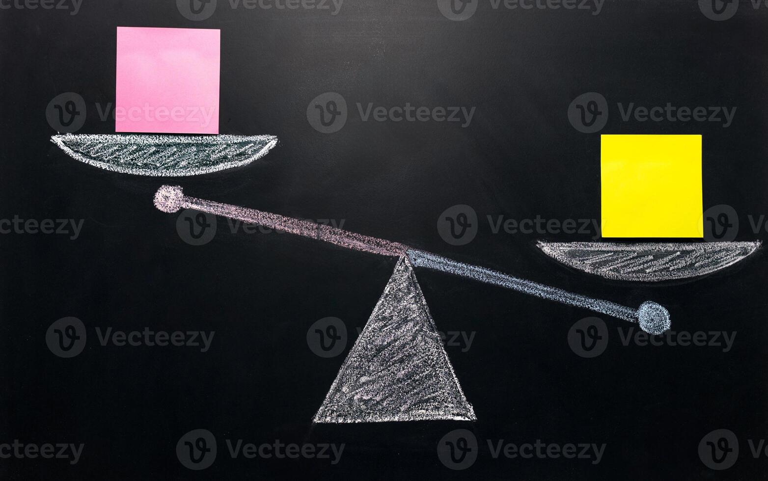 comparison mock up, scale drawn with chalk on black board, with two yellow and one pink stickers photo