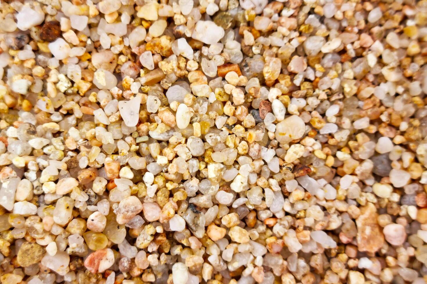 Close-Up of Colorful Pebbles and Sand Texture for Nature Background Design photo