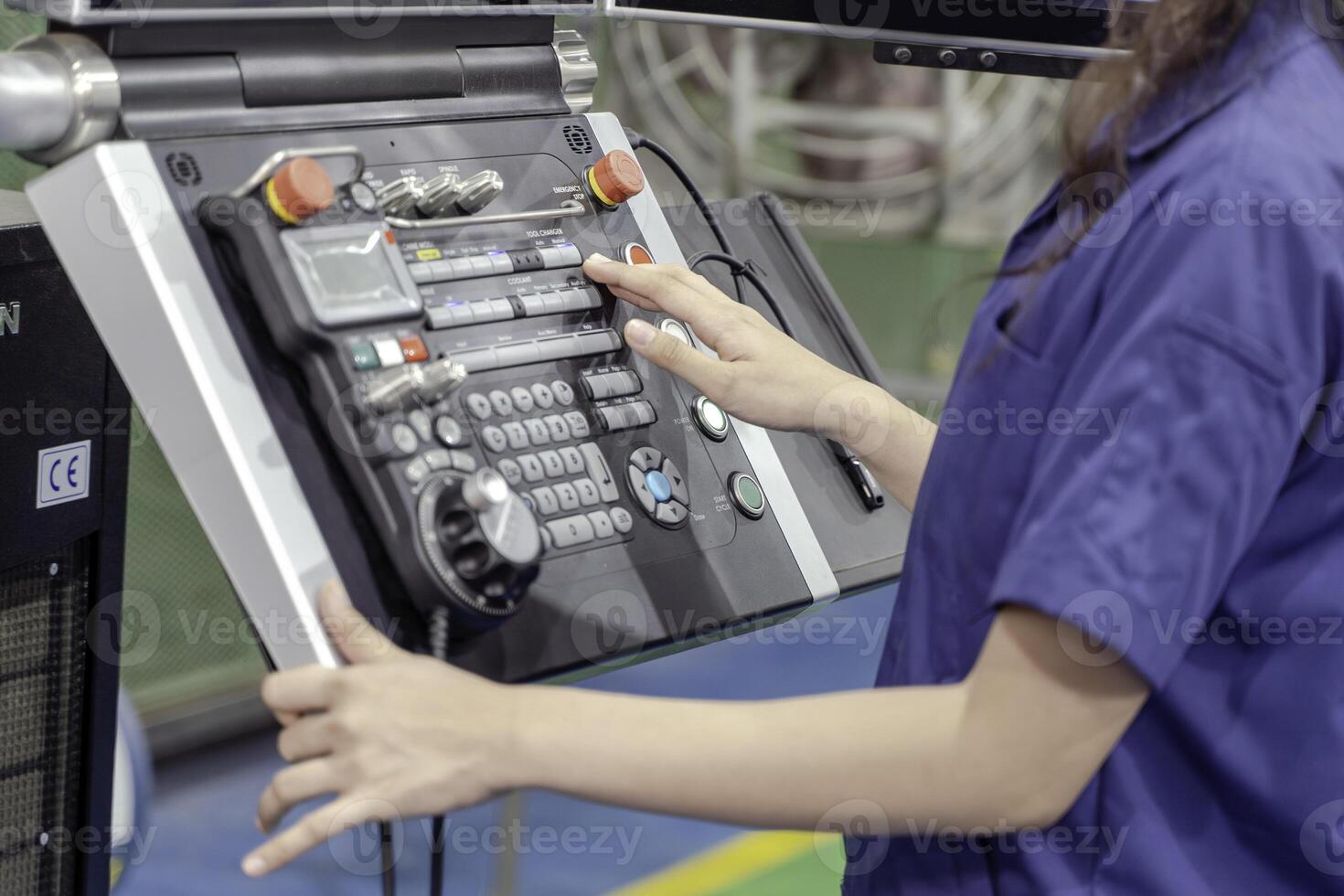Closeup and crop hand of technician Engineer wearing uniform touch, press the button of automated machinery in industrial workshop. photo