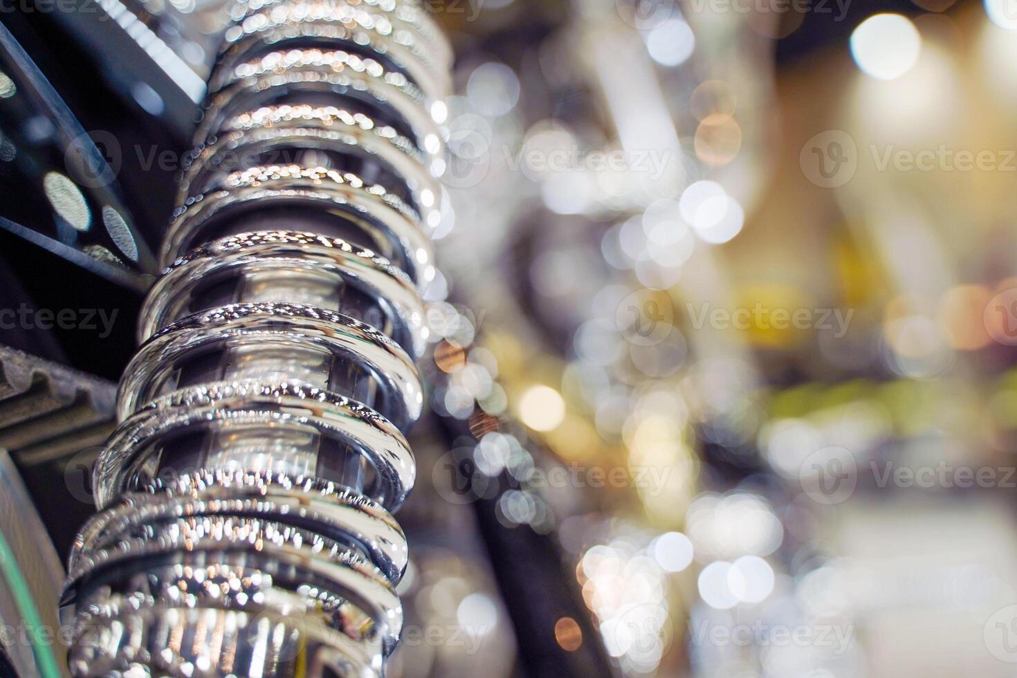 Closeup rear shock absorber of Chopper and cruise motorbike with chrome colors on blurred background. photo