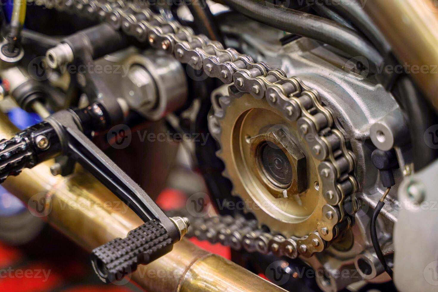 Closeup and crop motorcycle engine drive system with chains and sprockets photo