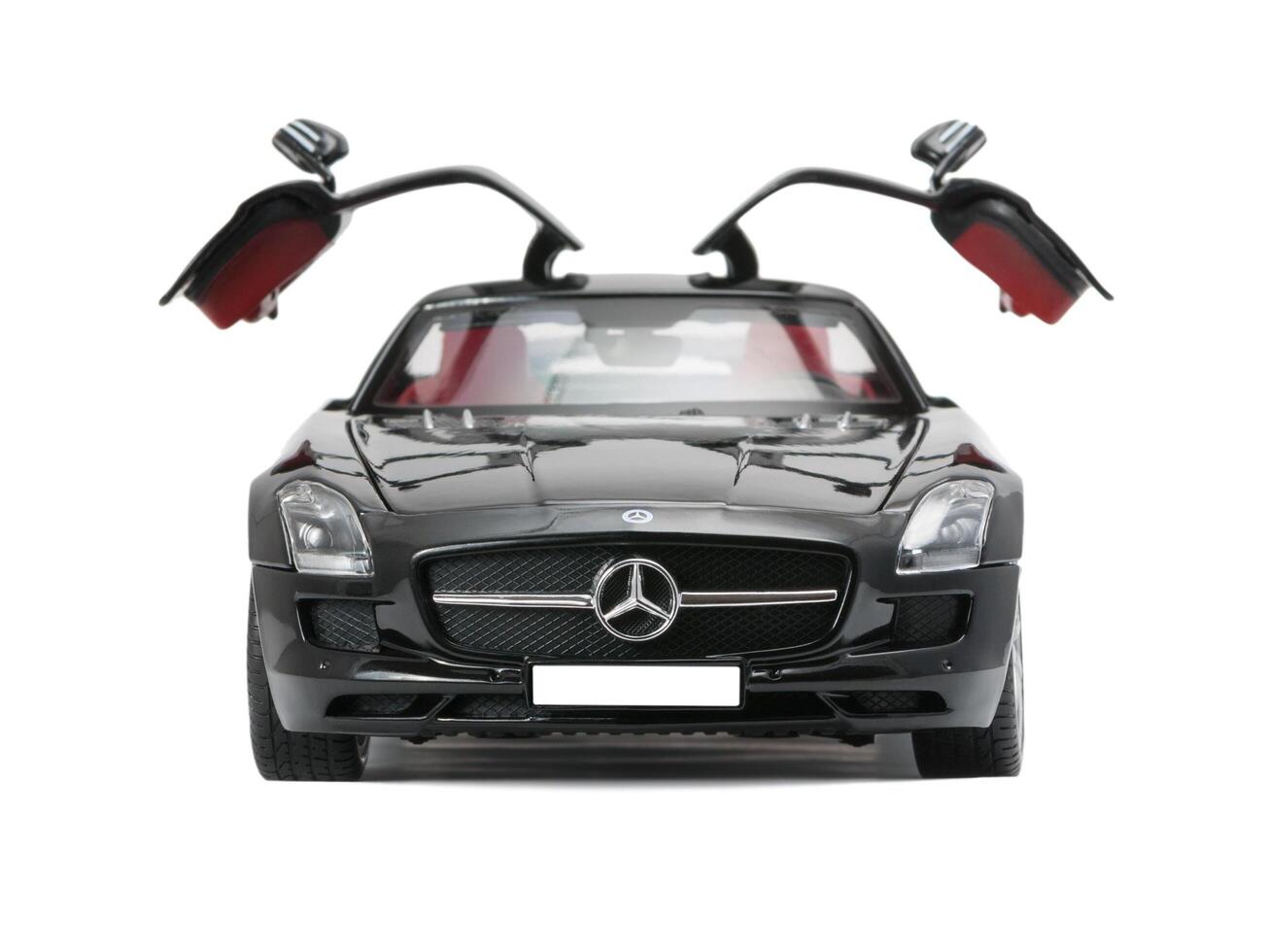ALMATY, KAZAKHSTAN - june 22, 2014 - Collectible toy car Mercedes-Benz SLS Sedan with open doors isolated on white background photo