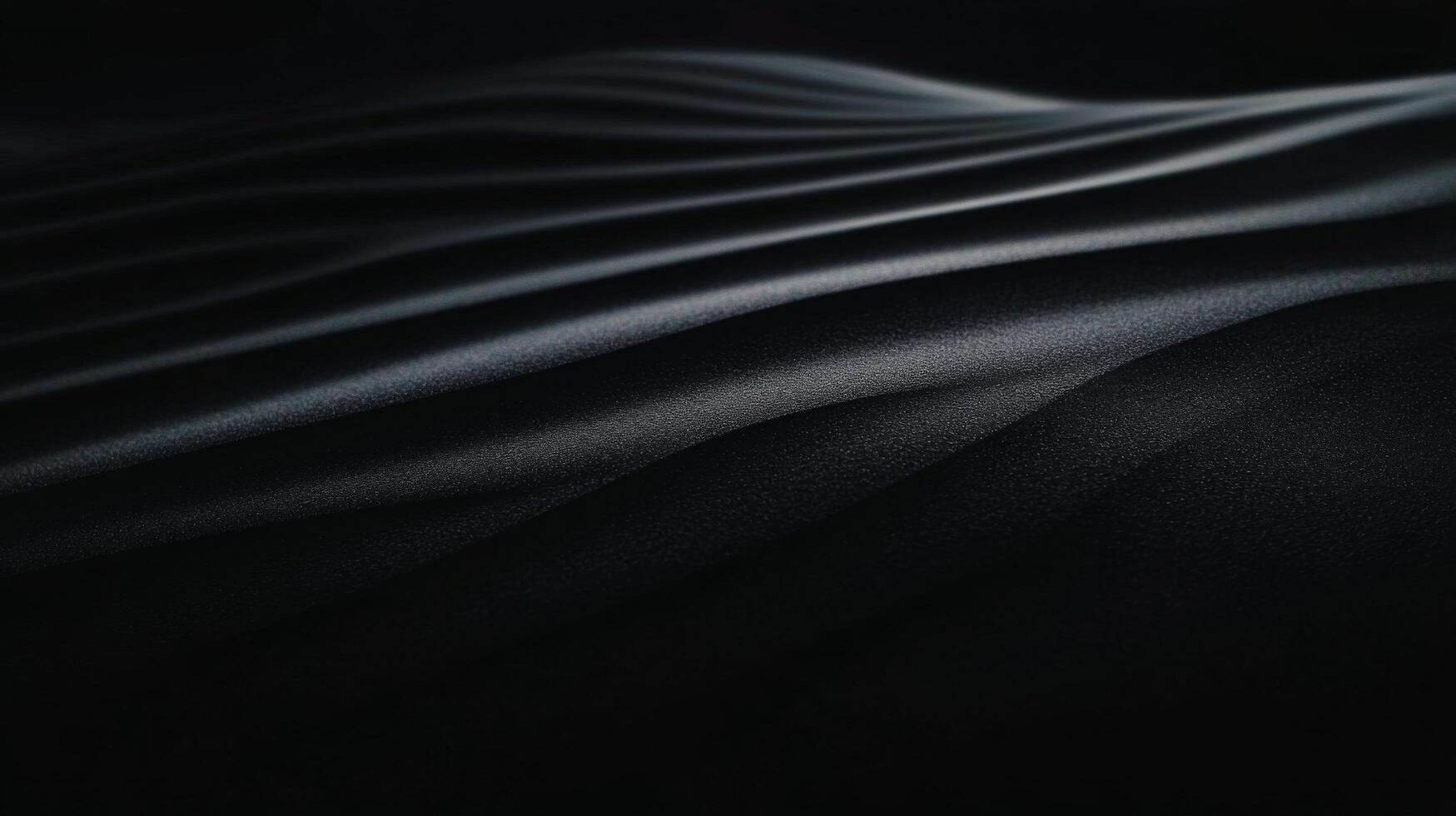 Soft contours of dark sand create elegant forms against subtle lighting photo