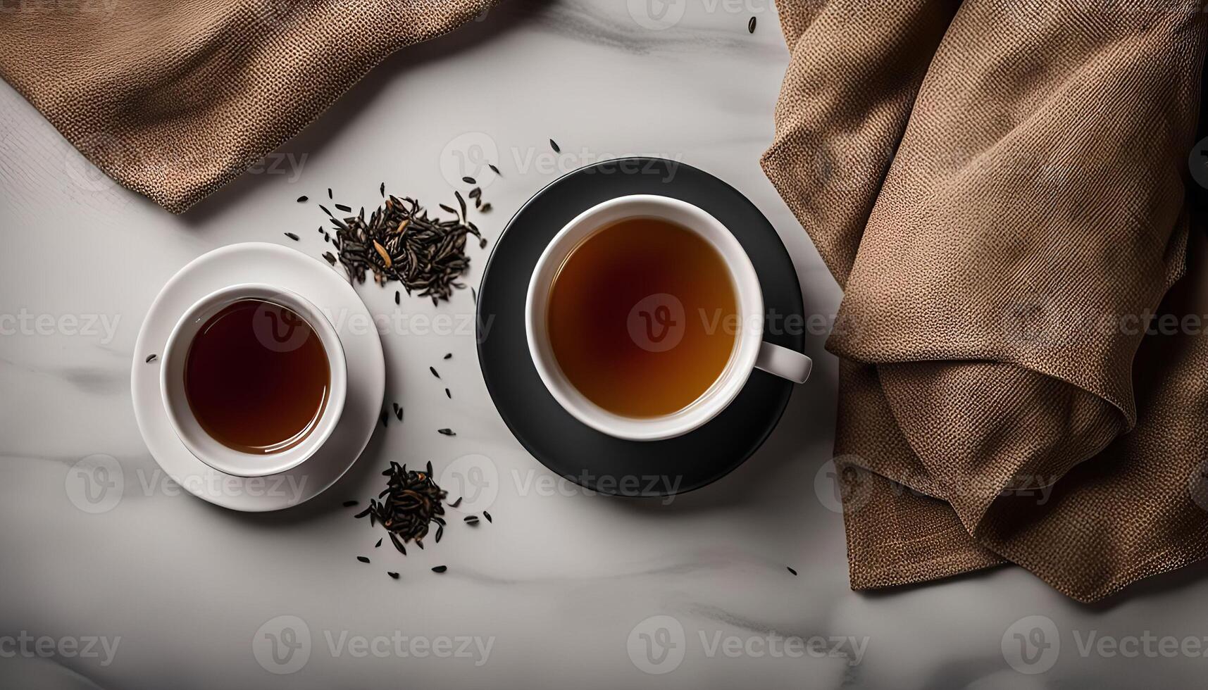 Two Cups of Tea and Tea Leaves on a Marble Surface photo