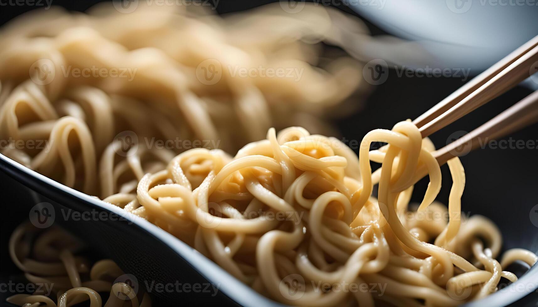 Noodles with chopsticks in a black container photo