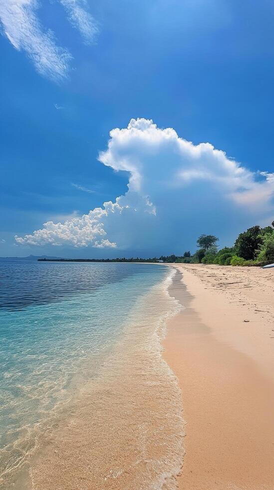 Serene tropical beach with clear water and vivid clouds in the background under a bright sky photo
