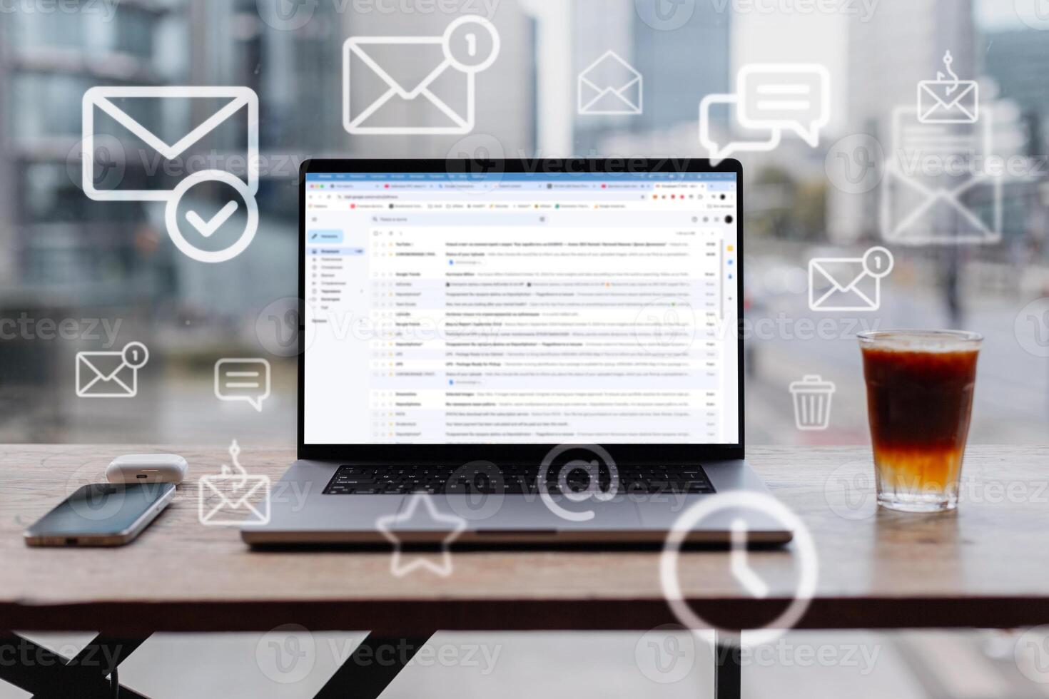 Laptop with open webmail service site and flying mail icons in office stands on table on a urban background. Mail and work, concept. Incoming mail, creative idea photo