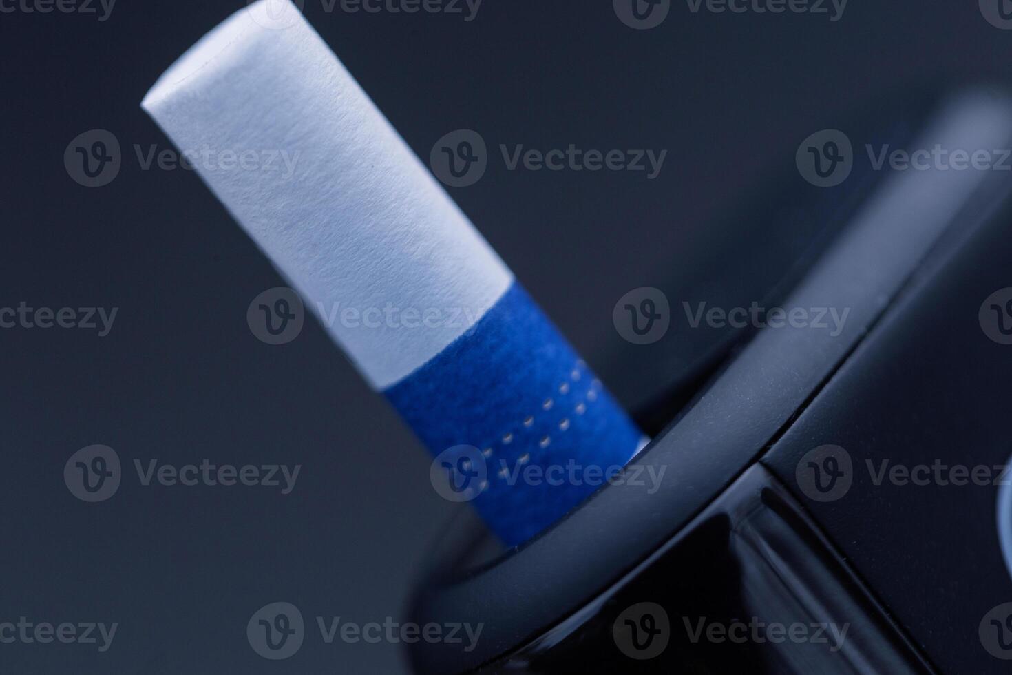 Modern cigarette without burning tobacco, close-up. Heated tobacco product photo