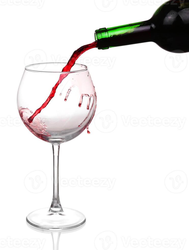 Red wine pouring on white background photo