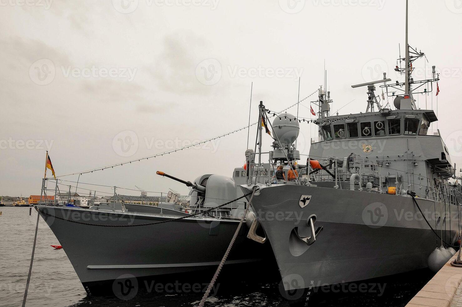 A gray boat docked in the water photo