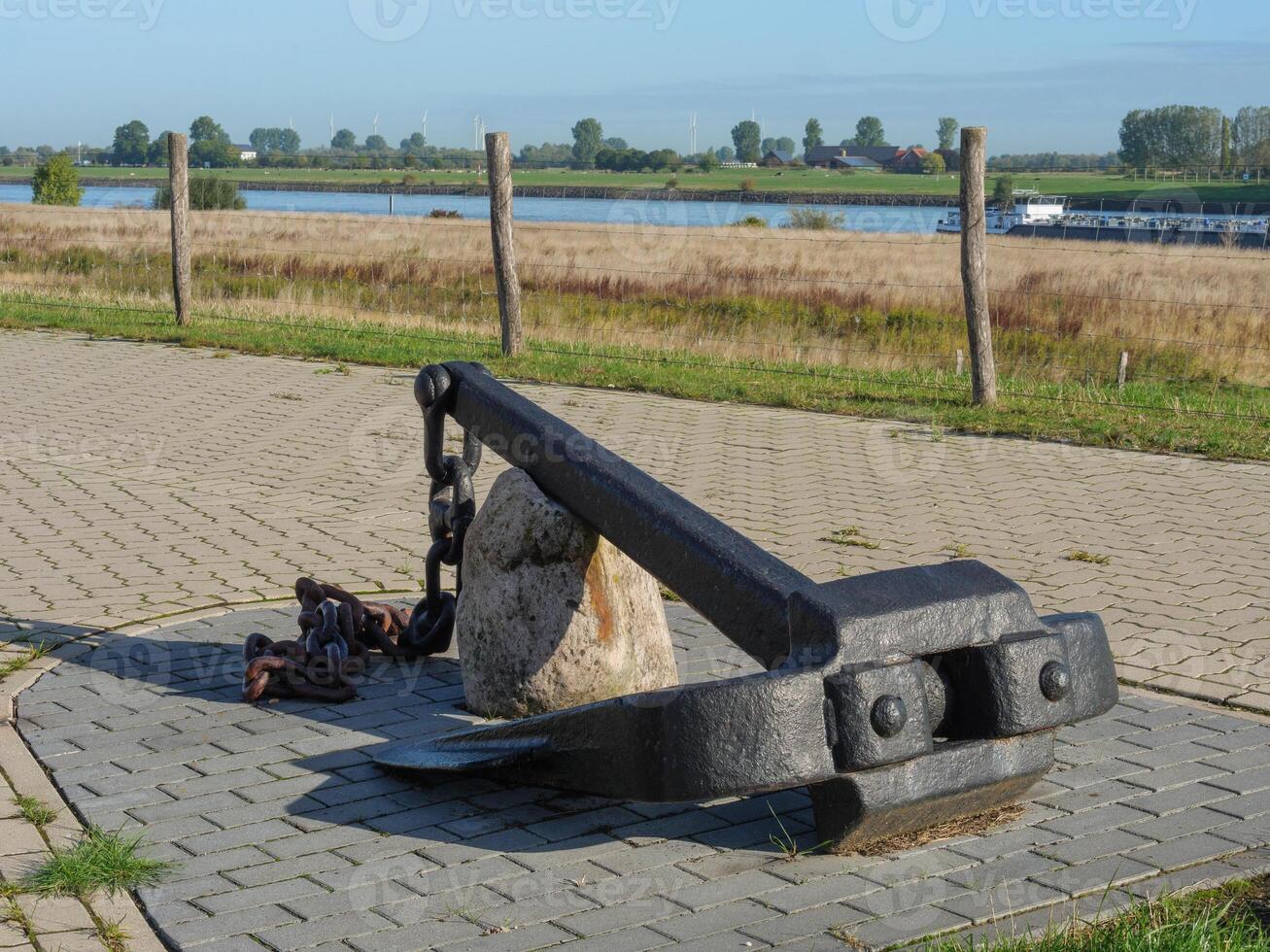 A large anchor on the ground photo