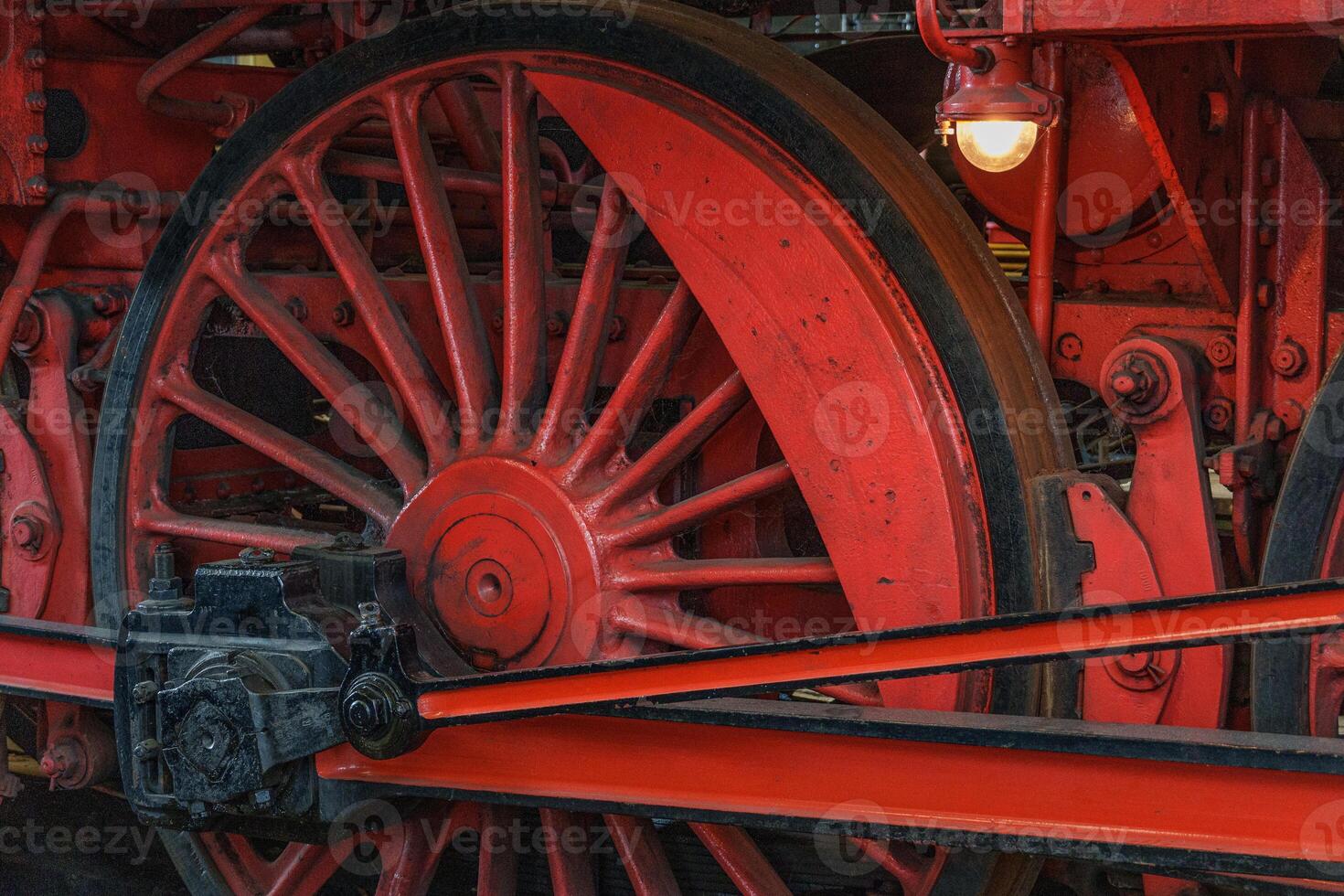 The wheels of an old red steam engine photo