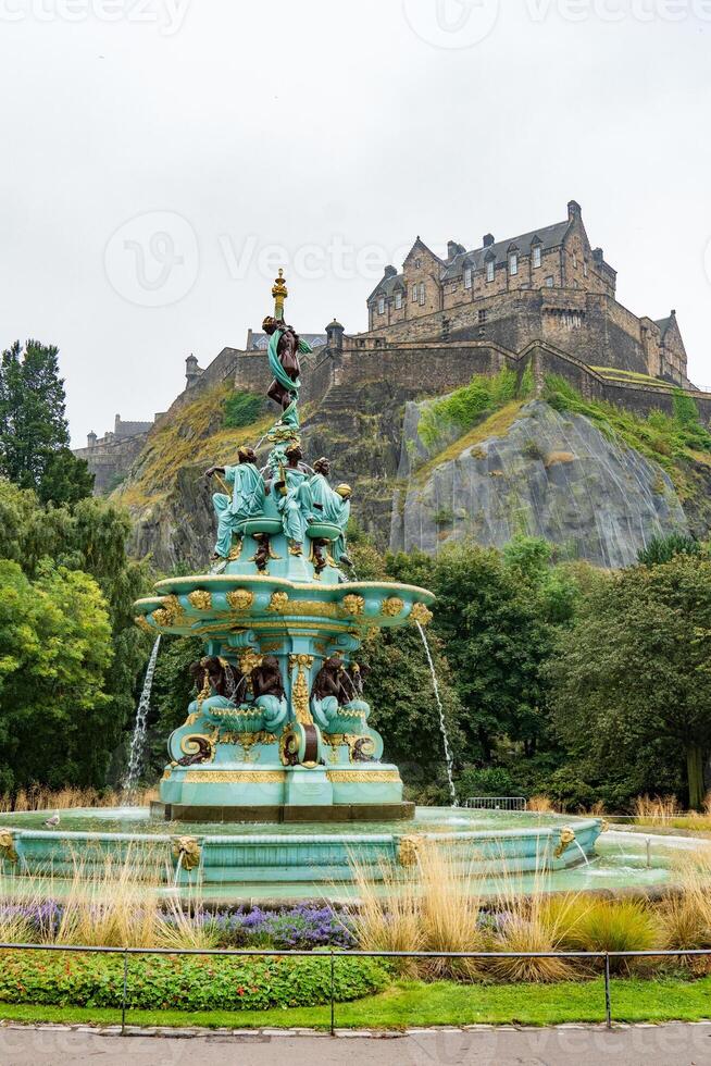 A fountain in front of a castle in edinburgh photo
