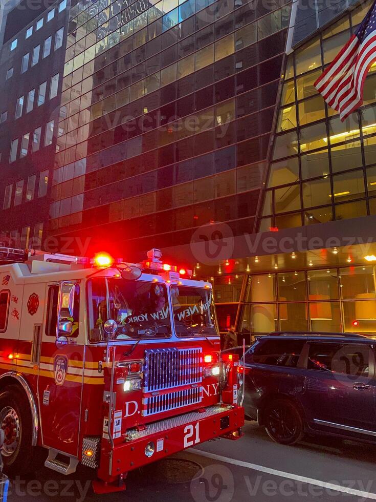A fire truck is parked in front of a building photo