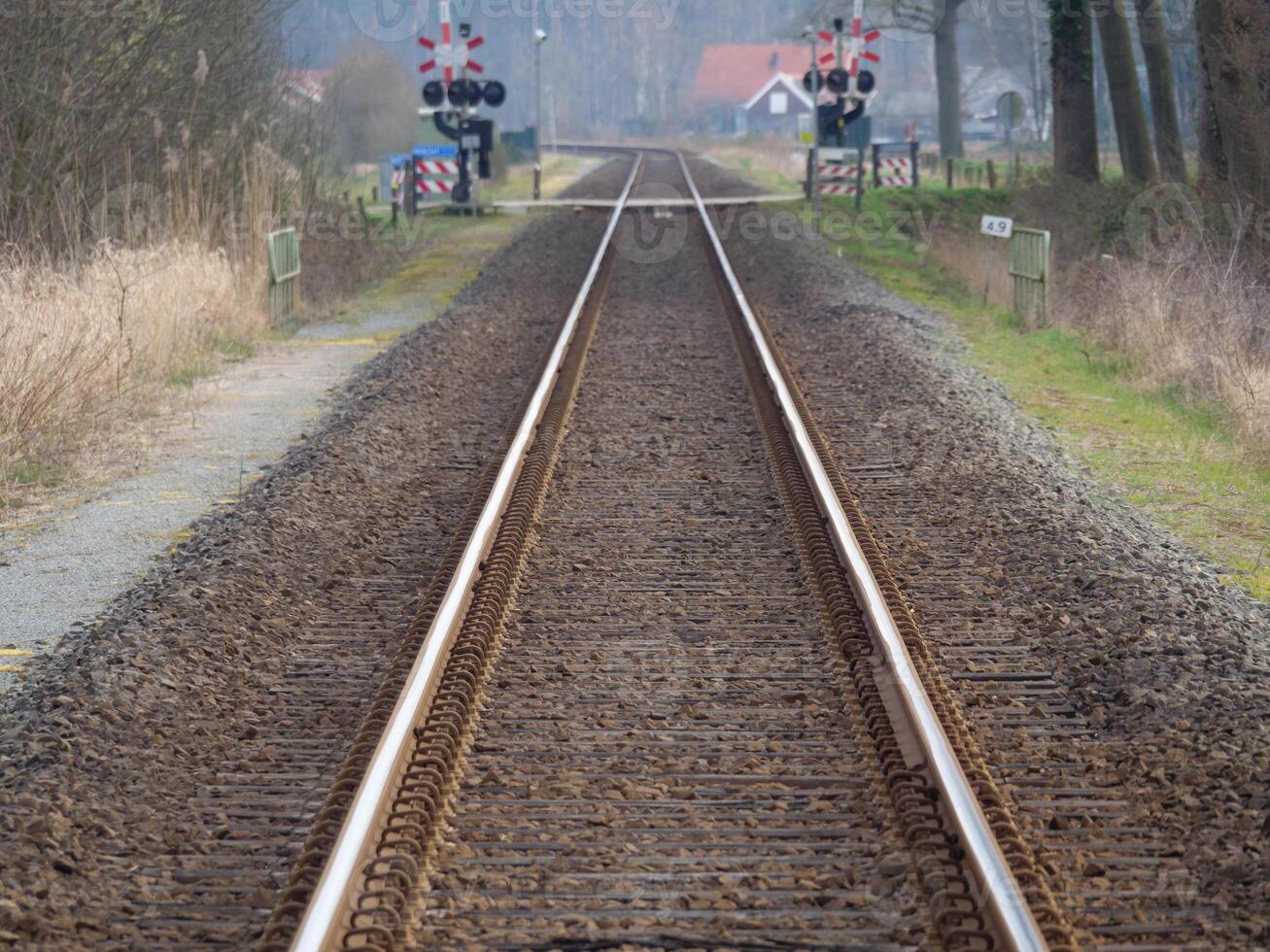 A train track with a red light on it photo