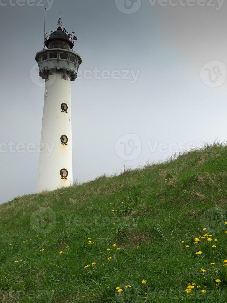 A white and black lighthouse in egmond photo