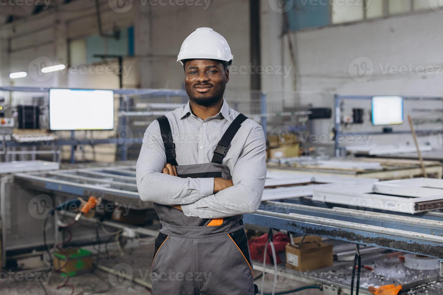 Supervisor posing with crossed arms in a window factory photo