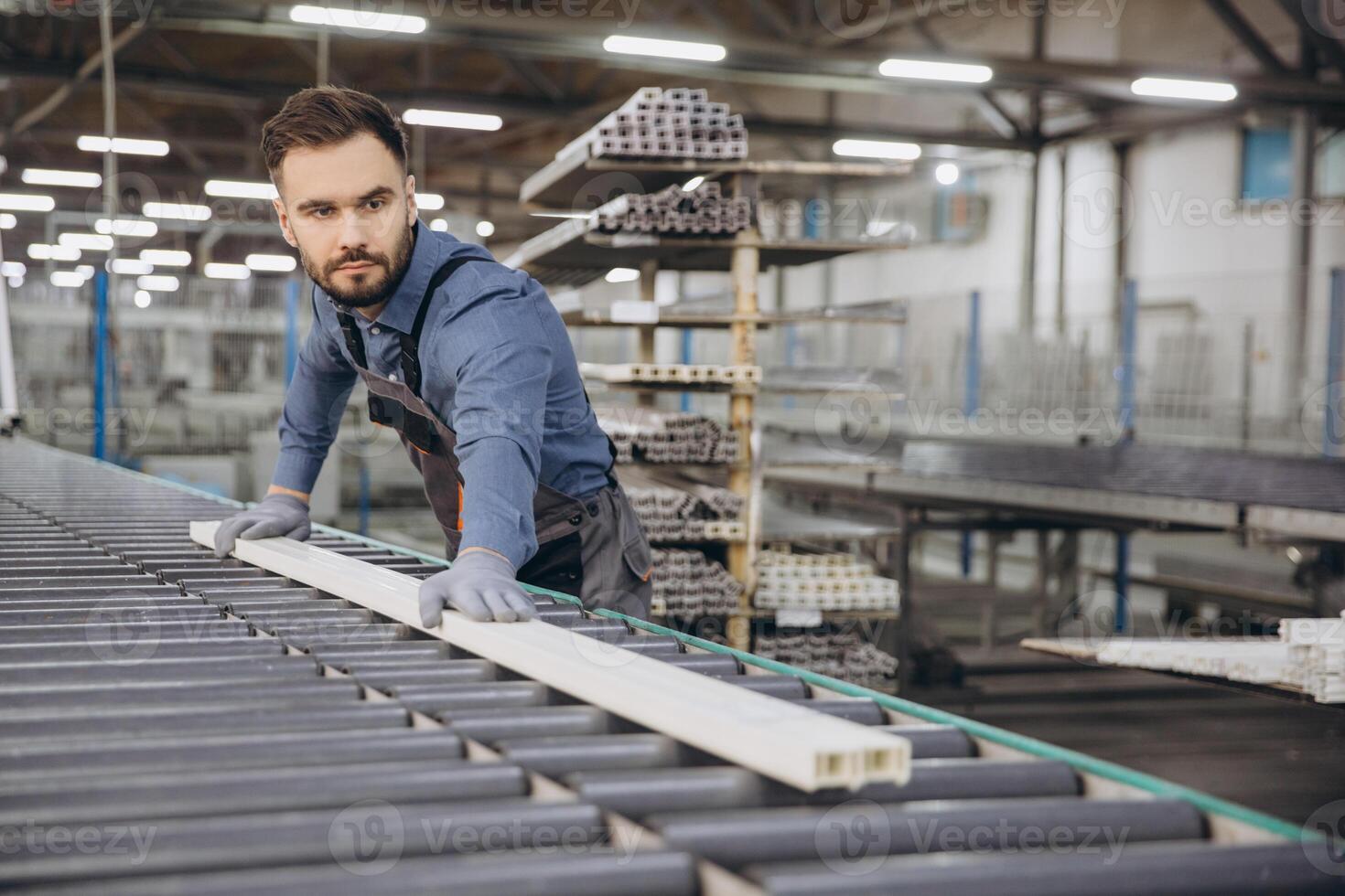 Factory worker handling pvc window frame on production line photo