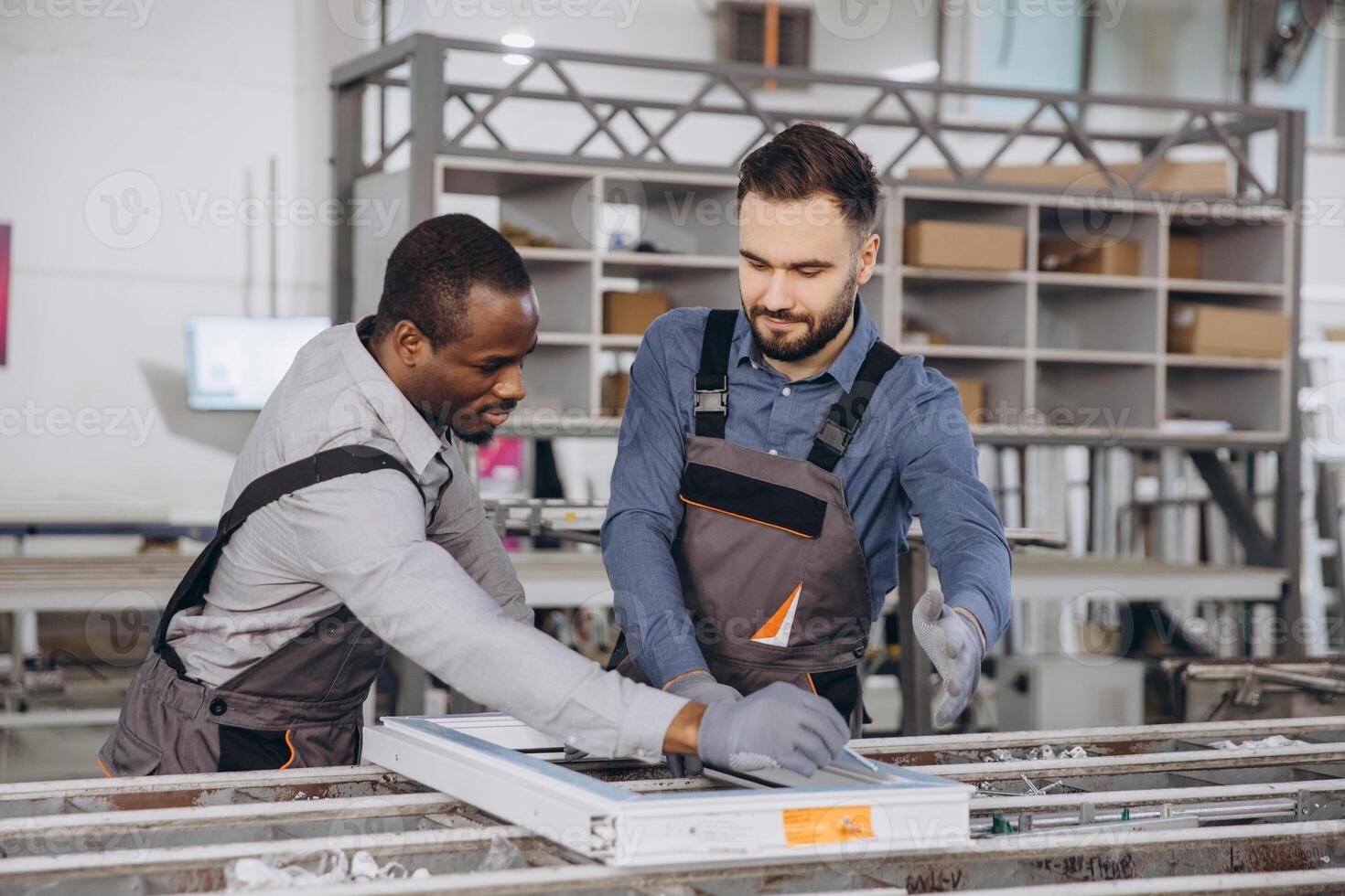 Factory workers assembling aluminum and pvc window frame photo