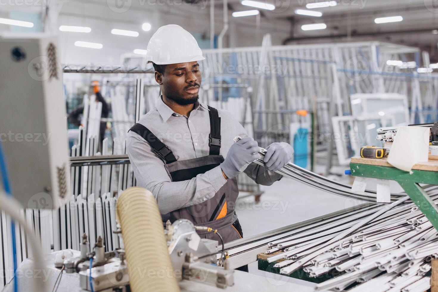 Factory worker assembling aluminum window frames in production line photo