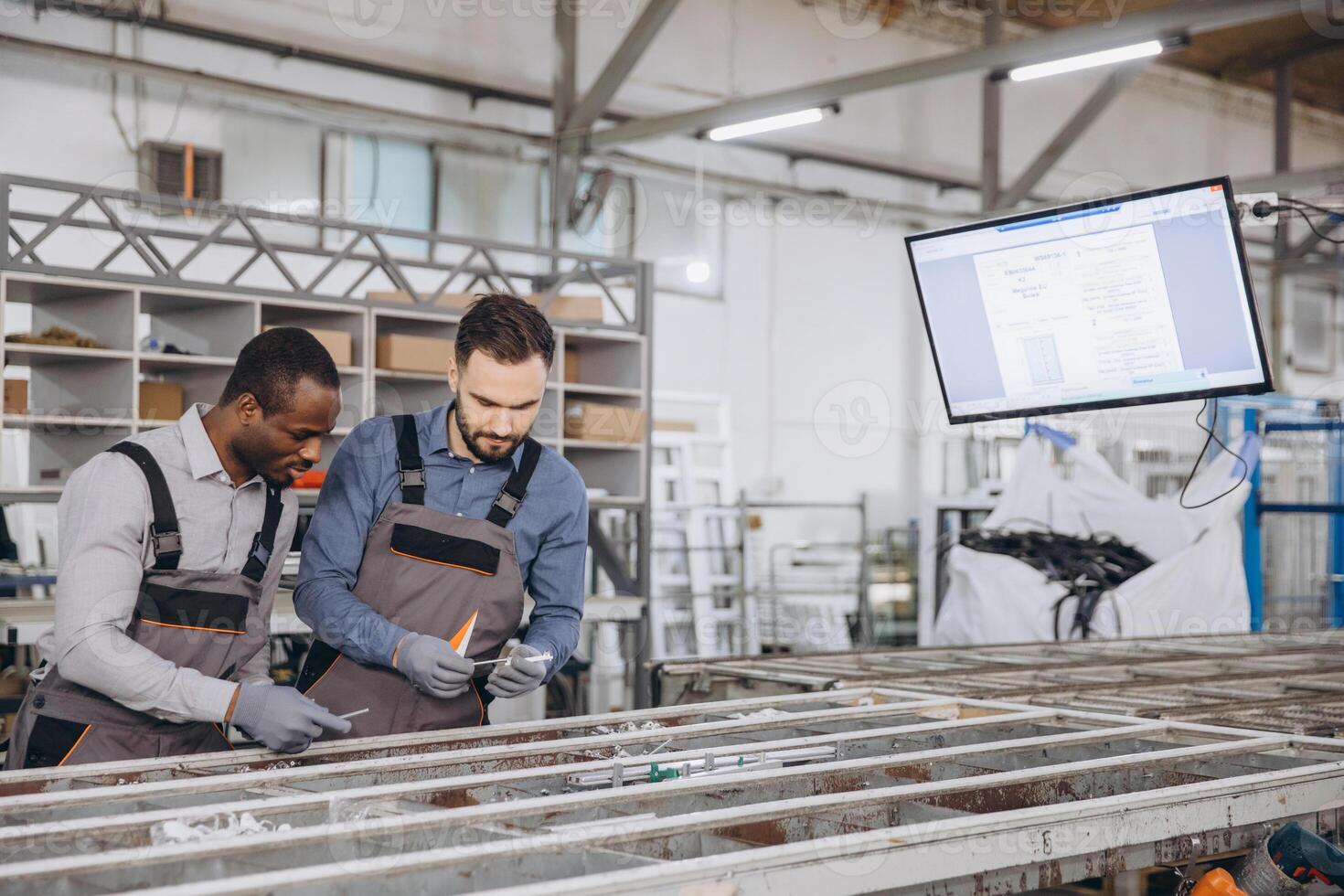 Factory workers assembling aluminum and pvc windows and doors photo