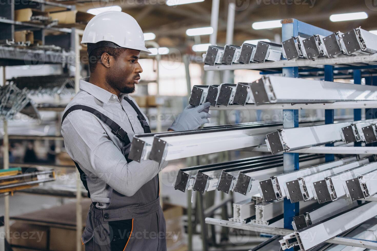 Factory worker checking aluminum and pvc window and door frames photo