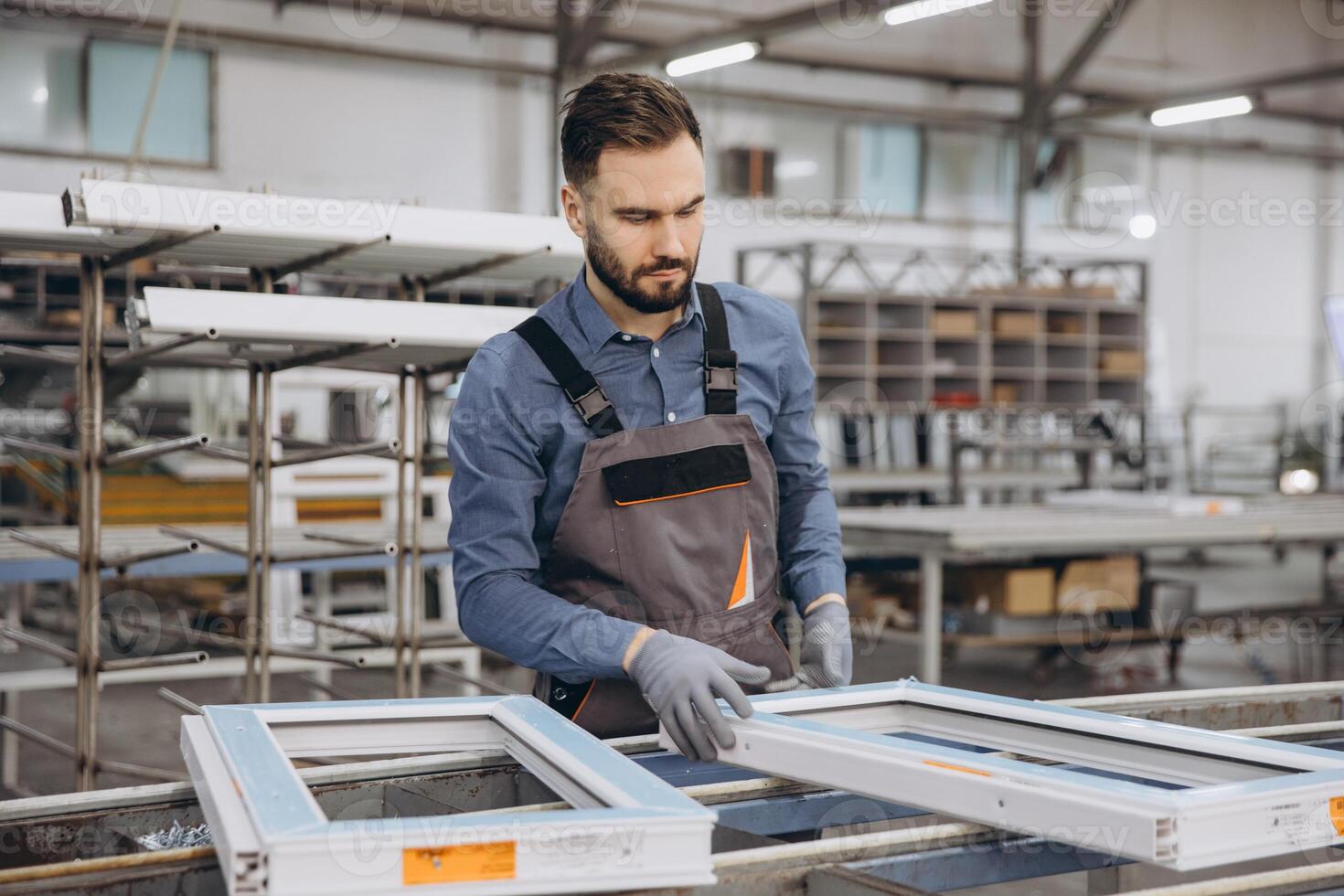 Factory worker assembling pvc window frame in workshop photo